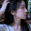 Fried egg earring on it